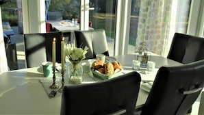 A dining table with chairs, candles, and a plate of food. - Diekkier Modern Retreat (Dollerup)