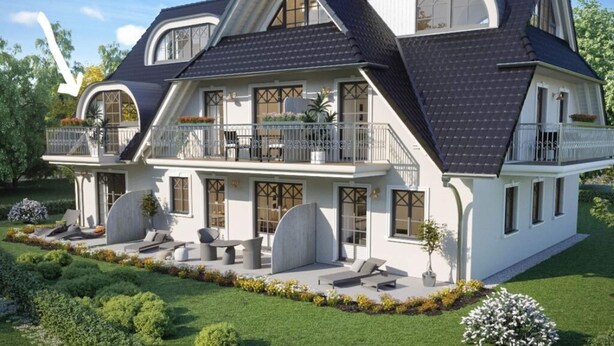 A large, two-story house with a dark roof, white exterior, and multiple balconies.