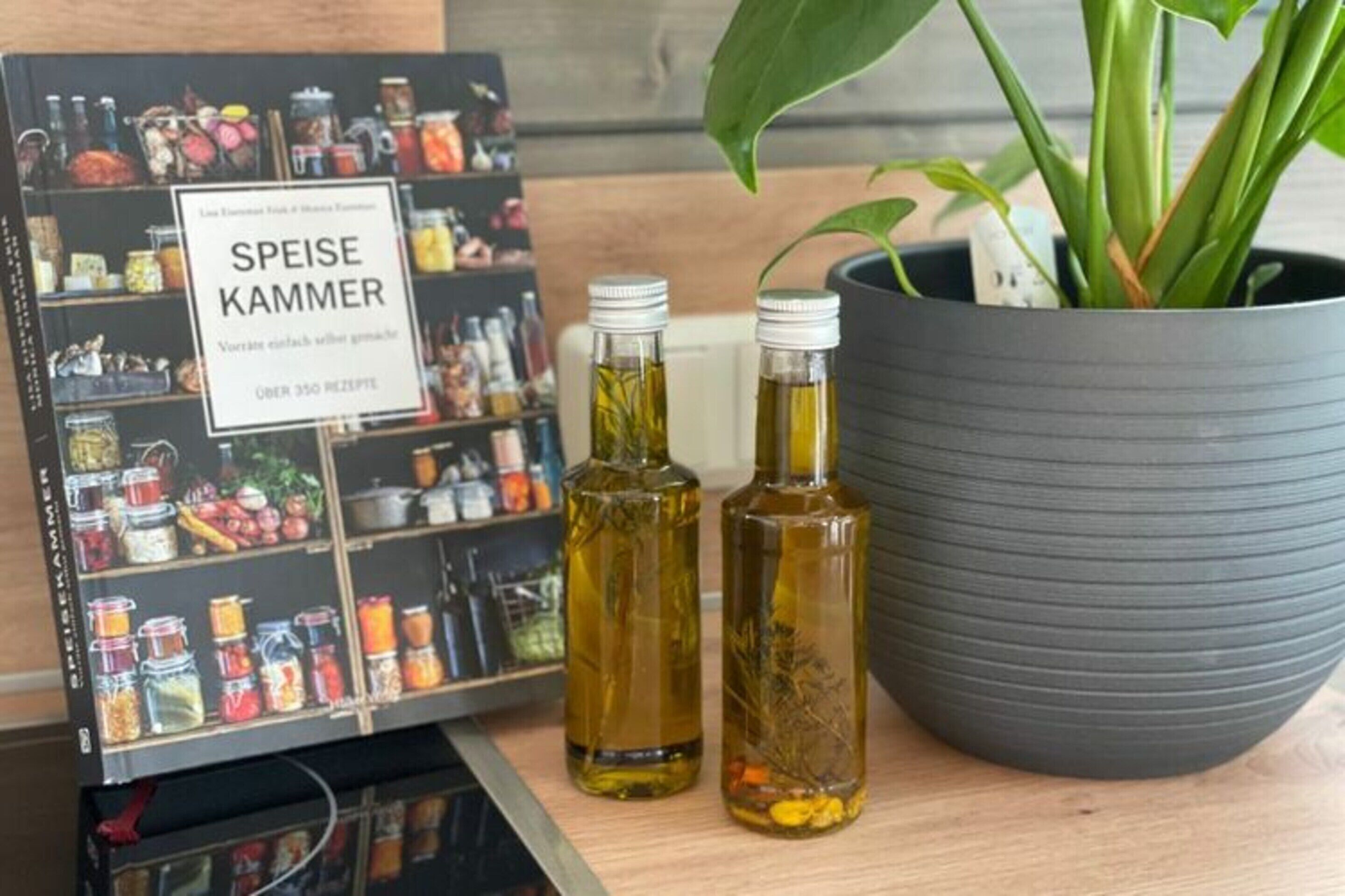 A display of various food products and two bottles of oil.