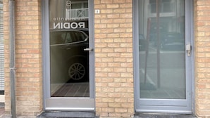 A building with two doors, one of which has a glass window with the number 8 and the word "RODIN" visible. - Apartment in Nieuwpoort Near the Beach (Nieuwpoort)