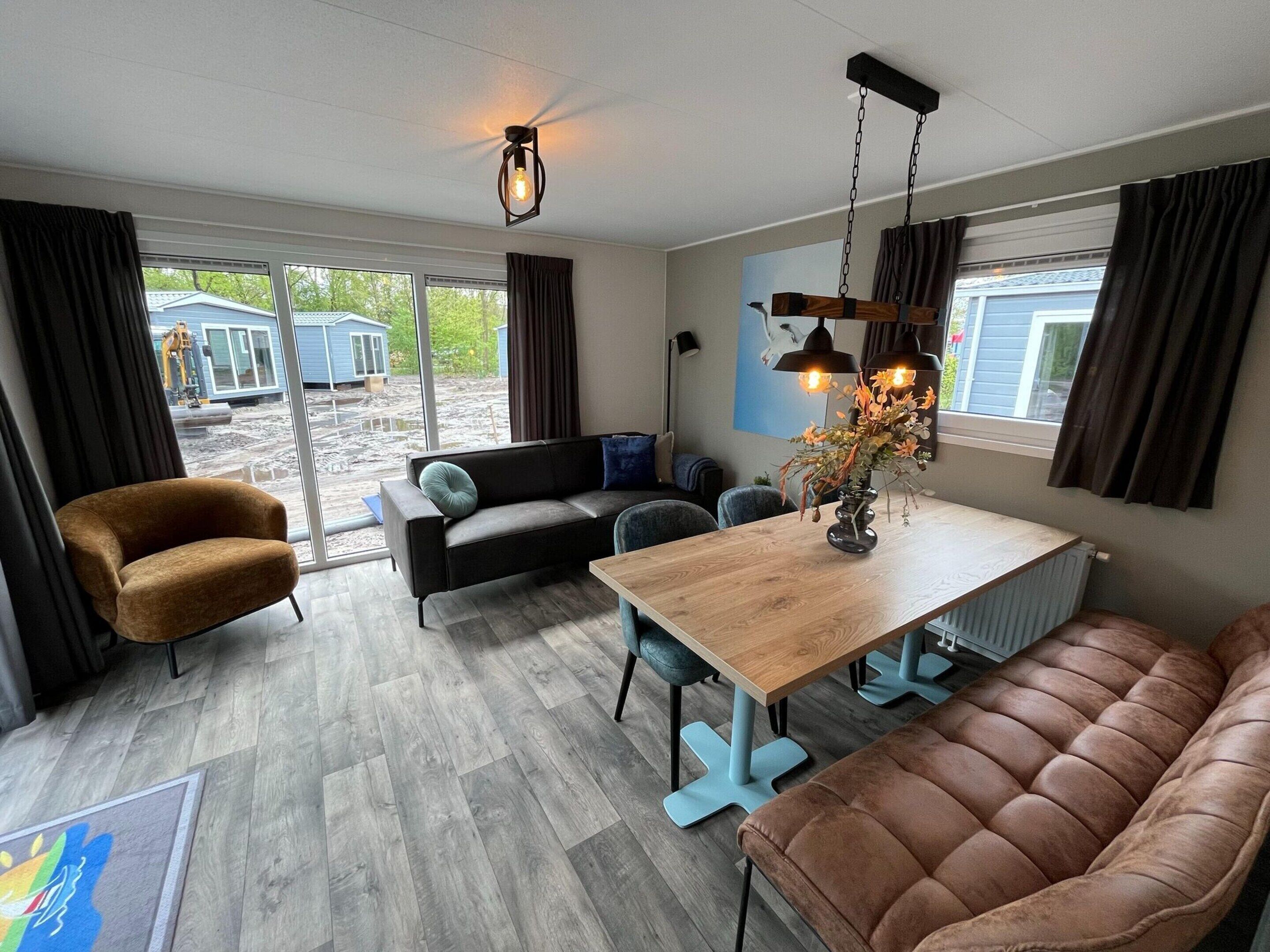 A modern interior with a sofa, a dining table, and a chair.