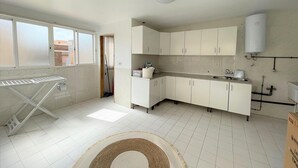 A kitchen with white cabinets, a built-in oven, and a window. - Belvilla by OYO Holiday Home in Los Alcazares (Los Alcazares)