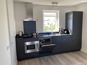 House | Private kitchen | Stovetop, electric kettle, high chair - Lakeview Villa With Swimming and Fishing Pier (Simonshaven)