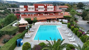 Seasonal outdoor pool, open 9:00 AM to 8:00 PM, pool umbrellas