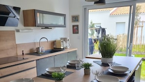 Une cuisine moderne avec un coin repas aménagé pour quatre personnes.