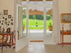 Enjoy a serene view of the garden from the comfort of your room, featuring a dining area and a cozy seating space.