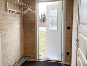 A wooden interior with a door leading outside, a coat rack, and a small window. - 3 Person Holiday Home in Grimstorp (Grimstorp)
