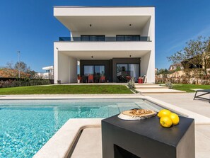 A modern two-story house with a swimming pool in the foreground. - Zen Comfortable Holiday Residence (Medulin)