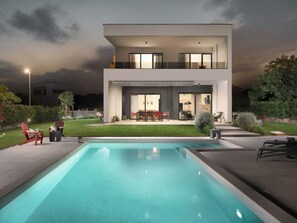 A modern two-story house with a swimming pool, outdoor seating, and a well-maintained lawn. - Zen Comfortable Holiday Residence (Medulin)