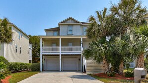 A two-story house with a front porch, two garages, and a mailbox. - ⚓Anchors Away: Pet-Friendly | Rooftop Deck | 4 Blocks to Beach⚓ (Kure Beach)