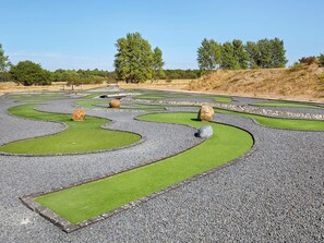 A landscaped garden with winding paths and green patches. - 6 Person Holiday Park Home in Ebeltoft (Ebeltoft)