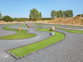 A landscaped garden with winding paths and green patches.