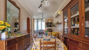 A dining area with a table set for six, wooden cabinets, and a large mirror. - 3897 Villa Margarita by Barbarhouse (Lecce)