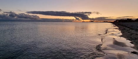 A calm body of water with a shoreline.