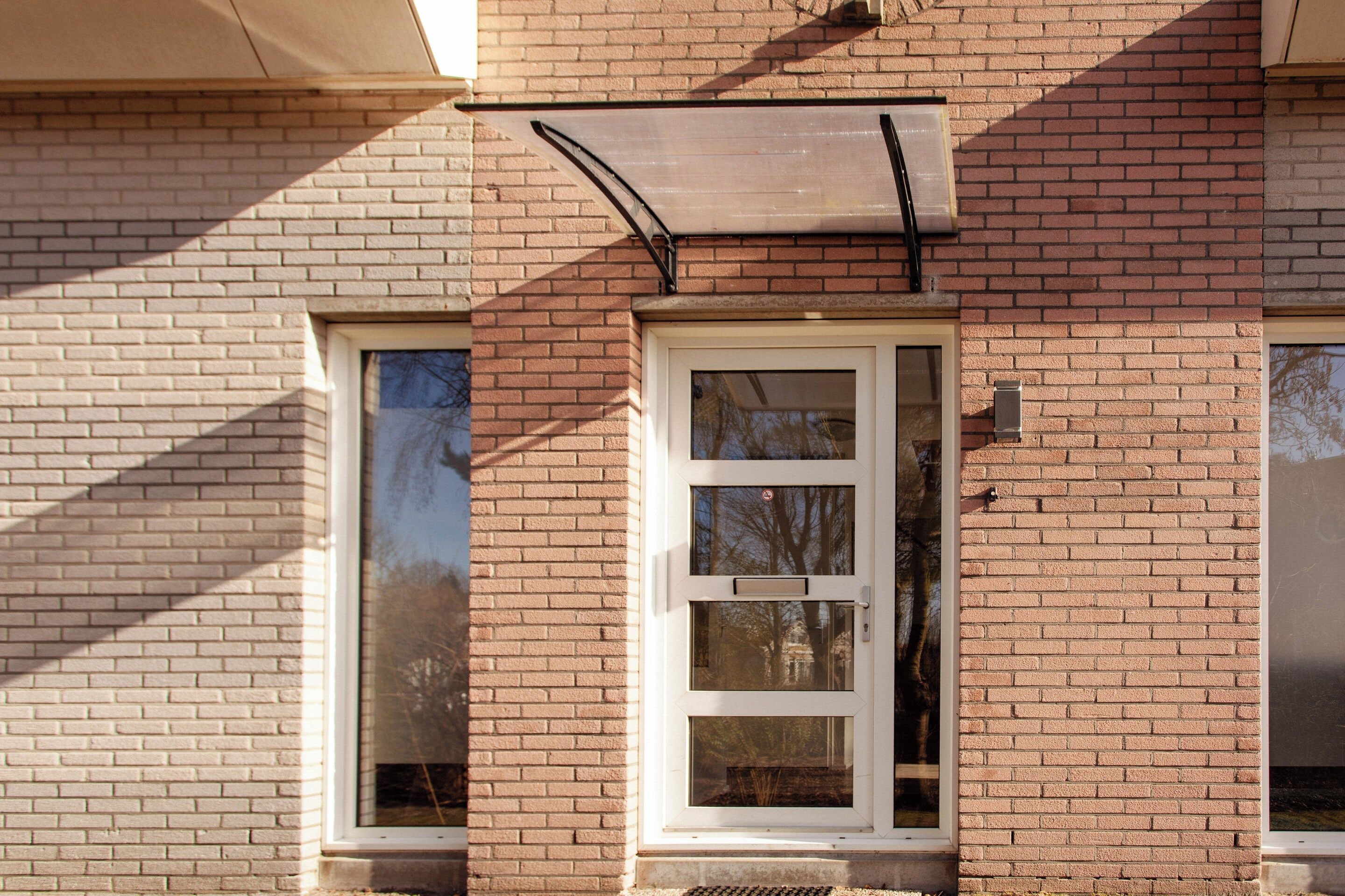 A building with a window and a metal awning.