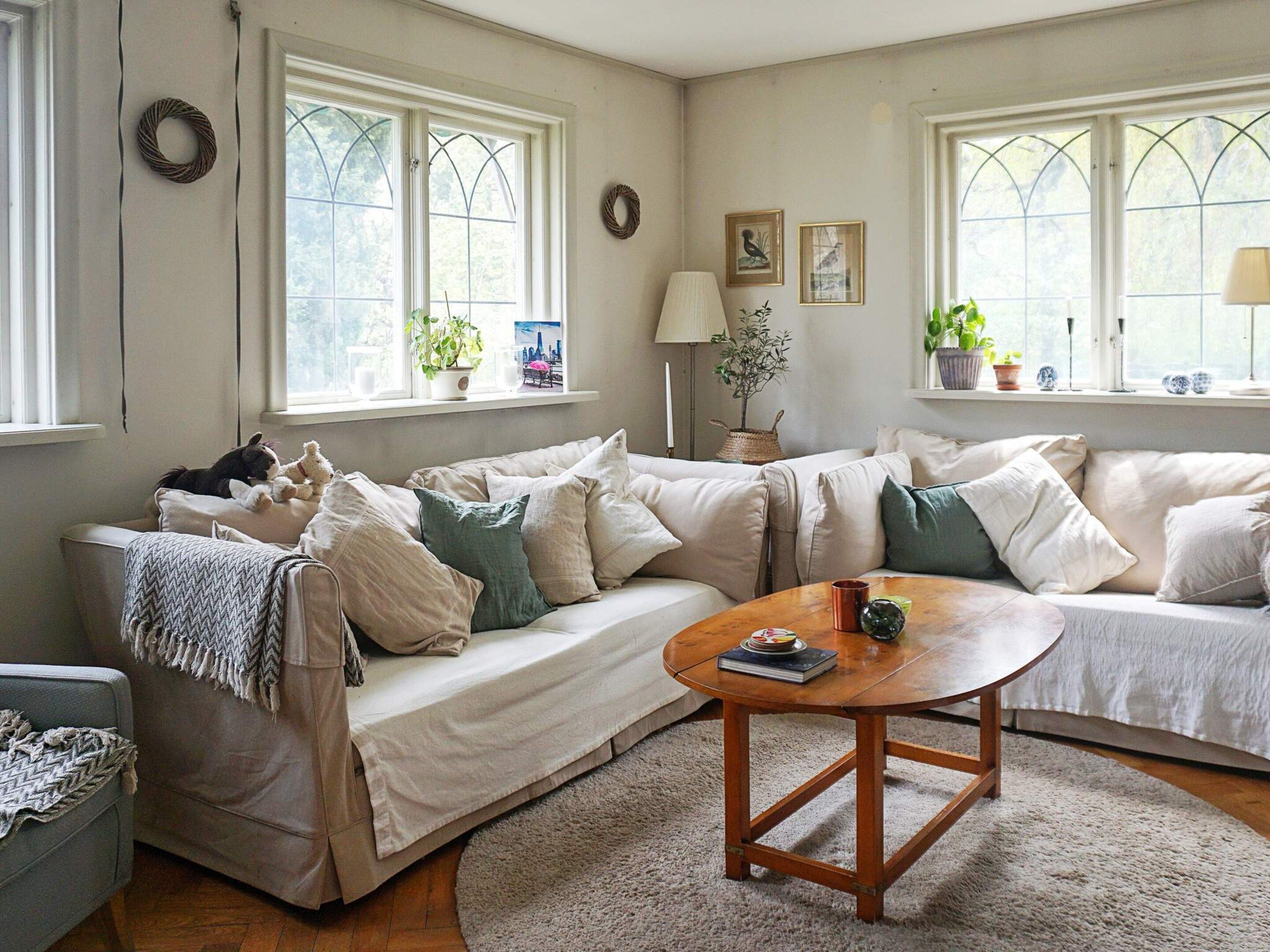 A cozy living room with a sofa, a coffee table, and a rug.