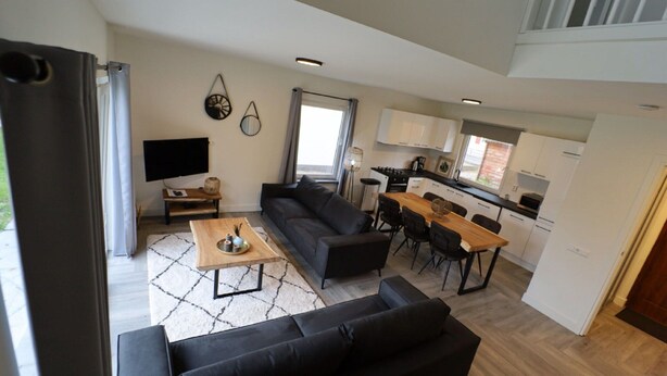 A modern apartment with a living room, dining area, and kitchen. - Detached Holiday Home Near Alkmaar (Hensbroek)