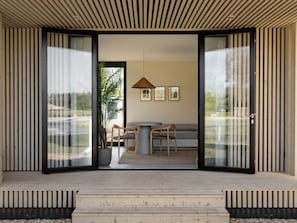 Relax in a spacious living area with a sliding glass door leading to a balcony offering a view of the outdoors.