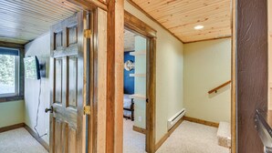 A room with a wooden door, a window, and a carpeted floor. - 24-0139 Cabin in Fairplay: Close to Trails! (Fairplay)