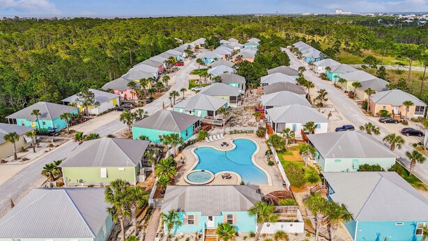 A resort with multiple bungalow-style houses arranged around a central swimming pool.