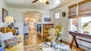 A spacious living room with a ceiling fan, a dining area, and a kitchen in the background. - Unique Tangier Cottage w/ Chesapeake Bay Views! (Tangier)