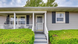 A single-story house with a front porch, a small front yard, and a visible door. - Walk to Restaurants: Stockton Home w/ Game Room (Stockton)