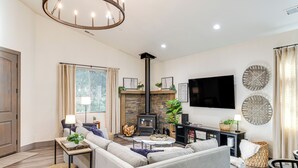 A modern living room with a fireplace, sofa, and television. - Game Room & Patio: Picturesque Home in Sonora (Sonora)