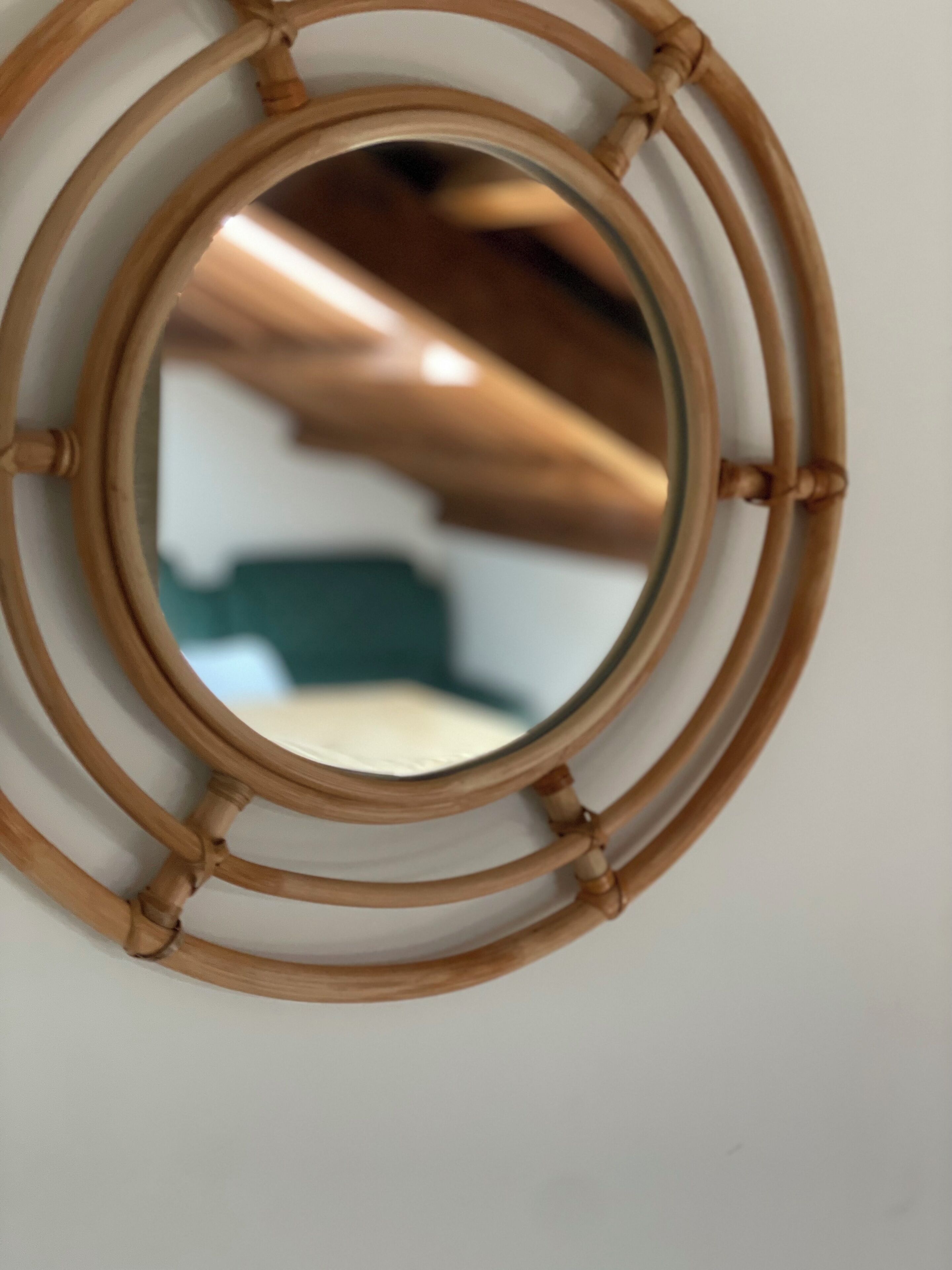 A circular mirror with a bamboo frame.