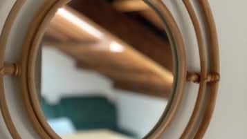 A circular mirror with a bamboo frame.