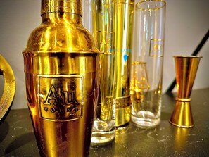 A collection of golden perfume bottles and glass containers on a reflective surface. - Croydon Cozy Retreat - 2 Bedroom Luxury Home (South Croydon)