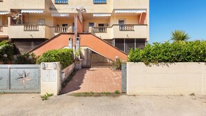 A multi-story residential building with balconies, a gated entrance, and a paved driveway. - 3895 RSM - Appartamento Ester by Barbarhouse (Manduria)