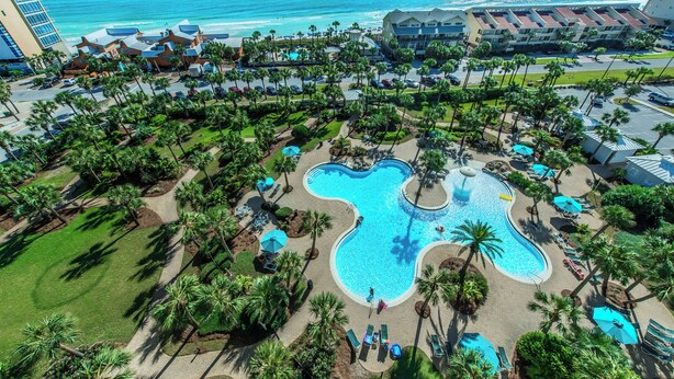 A resort with a large pool, palm trees, and a view of the ocean. - Walk 2 Beach~Spacious Balcony~100ft2Bch~Fab Lagoon Pool~Sterling Shores 307 (Destin)
