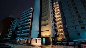 A modern multi-story building with balconies and a central entrance. - Randor Hotel Sapporo Suites (Sapporo)