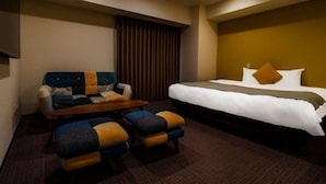 A hotel room with a bed, a sofa, and two armchairs. - Randor Hotel Sapporo Suites (Sapporo)