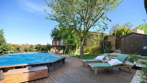 A wooden deck with a hot tub, lounge chairs, and a swimming pool. - Holiday Home 'Villa Avec Piscine Soupex' with Private Pool, Private Terrace and Wi-Fi (Soupex)