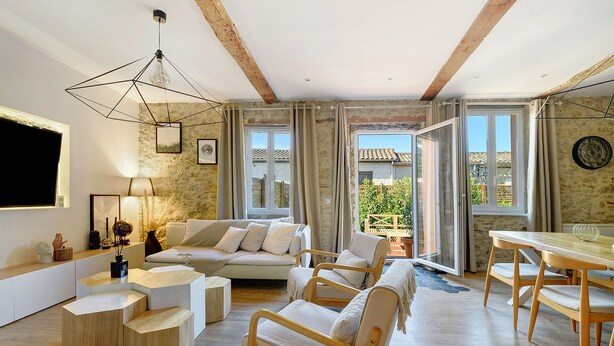 A modern living room with a sofa, chairs, a dining table, and a unique geometric light fixture. - Holiday Home 'Villa Avec Piscine Soupex' with Private Pool, Private Terrace and Wi-Fi (Soupex)