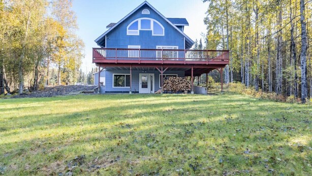 A two-story house with a balcony, surrounded by a forest. - Sterling Hideout on the Kenai Peninsula (Sterling)
