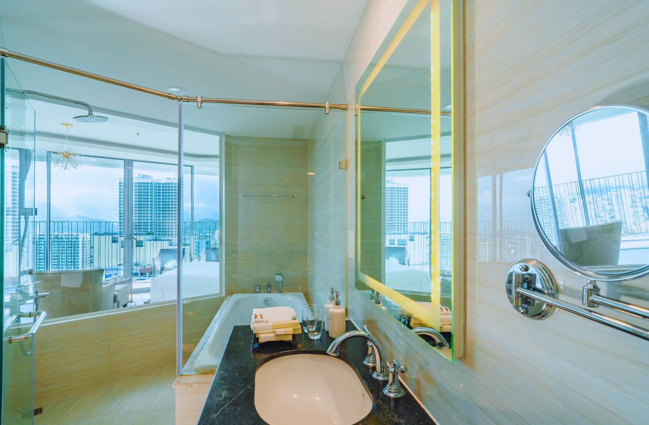 A modern bathroom with a large mirror, a bathtub, and a sink.