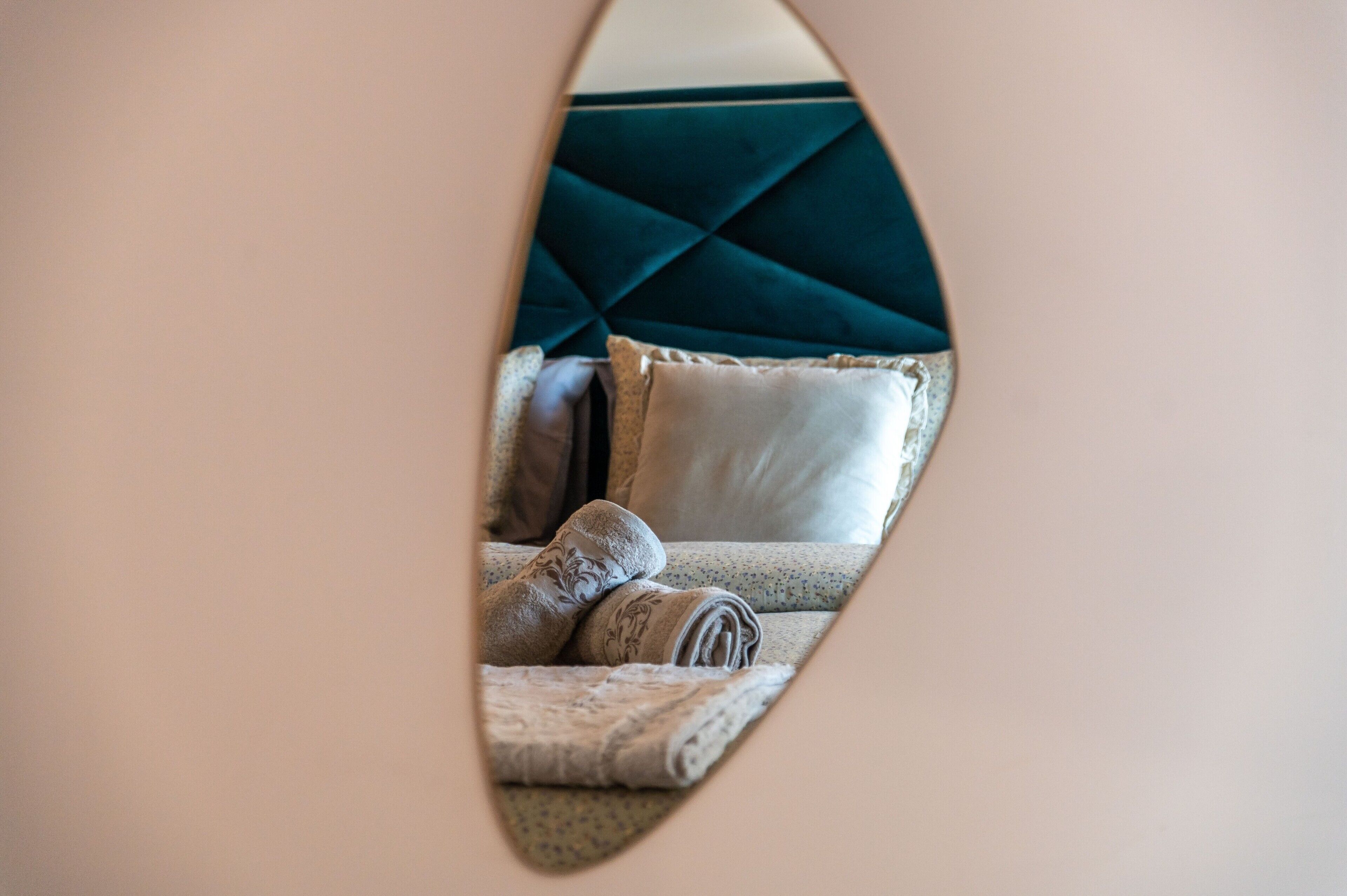 A bedroom with a bed, pillows, and a headboard.