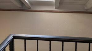 A skylight in a room with a view of a hillside and buildings. - Beautiful place  on the beach with gorgeous views, close to the restaurants. (Vinišce)