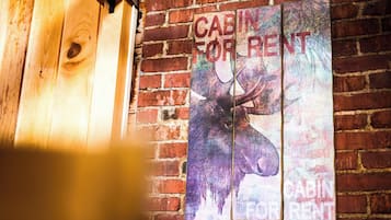 A wooden door and a wall with a 'Cabin for Rent' sign.