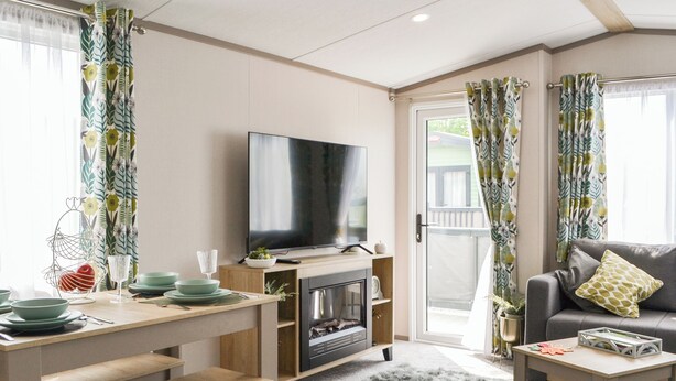 A living room with a flat-screen TV, a sofa, a coffee table, and a fireplace. - 2 bedroom accommodation in East Heslerton (East Heslerton)