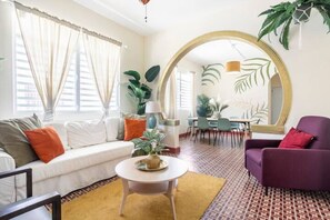 Signature Apartment, Balcony, Ground Floor | Living area | 55-inch flat-screen TV with cable channels