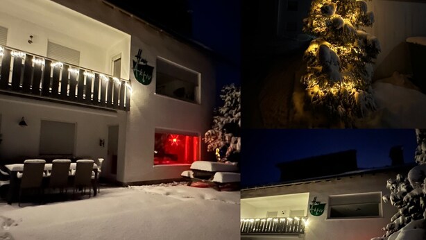 A modern building with a covered outdoor seating area, a snow-covered lawn, and a decorated Christmas tree. - Haus Aktiv Winterberg, Garten Apartment, Www.haus-aktiv.de - 2-6 Personen (Winterberg)