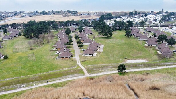A residential area with multiple houses, a central road, and a body of water. - 6 Person Holiday Park Home in Karrebaeksminde (Karrebæksminde)