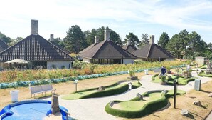 A landscaped garden with a pool, benches, and a pathway. - 6 Person Holiday Park Home in Karrebaeksminde (Karrebæksminde)