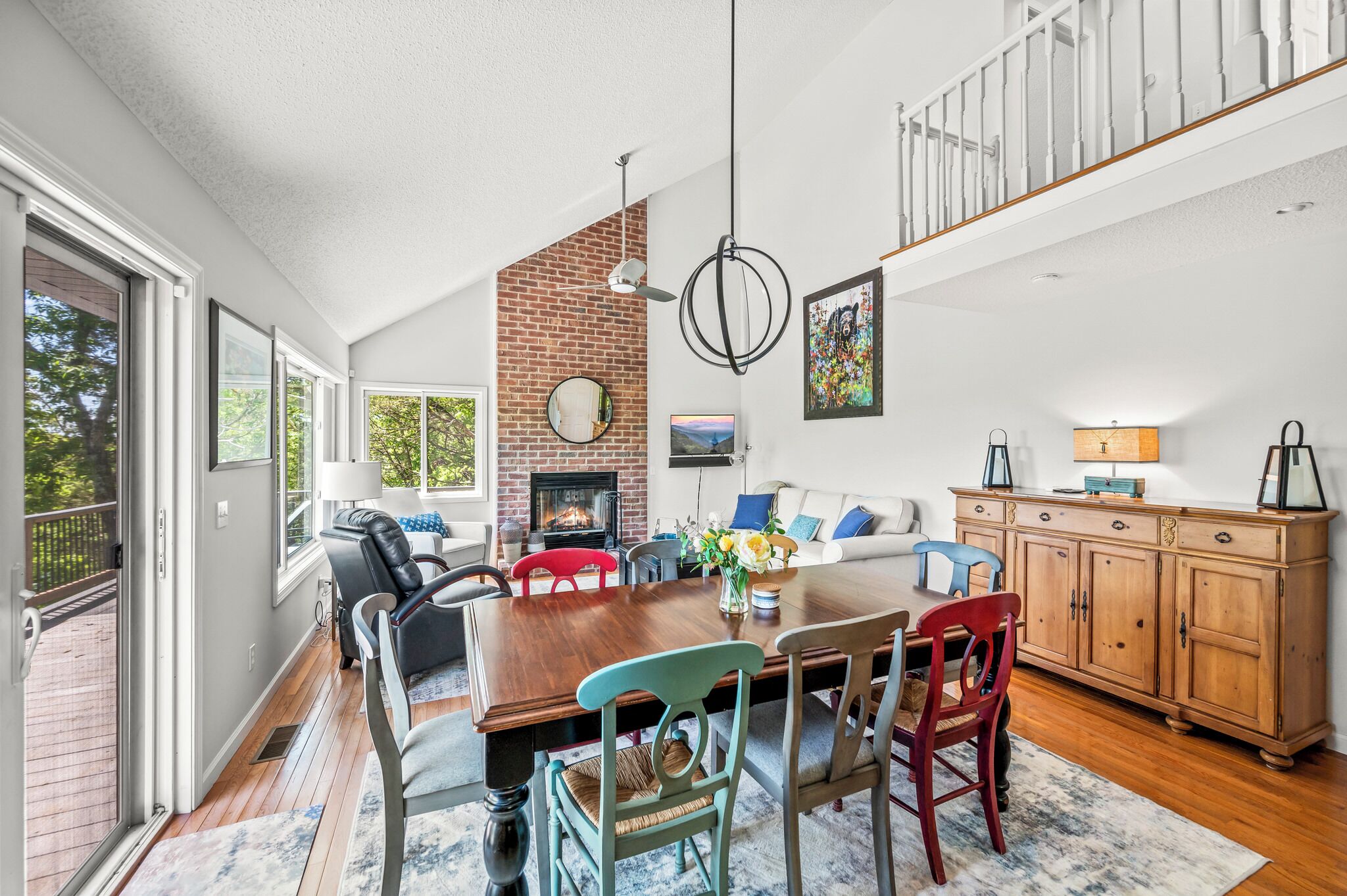 A spacious dining area with a wooden table, chairs, and a fireplace.