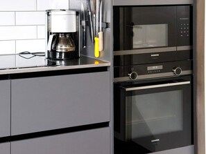 A kitchen with a coffee maker, knives, and a Siemens oven. - 4 Star Holiday Home in Halmstad (Halmstad)