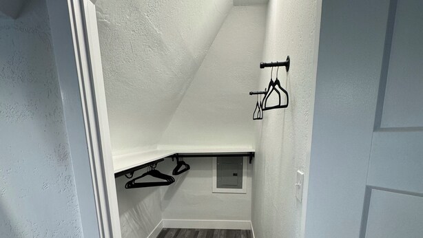 A narrow hallway with wooden flooring, white walls, and a recessed ceiling light. - One of the oldest houses in Butler, with an updated vibe. (Butler)