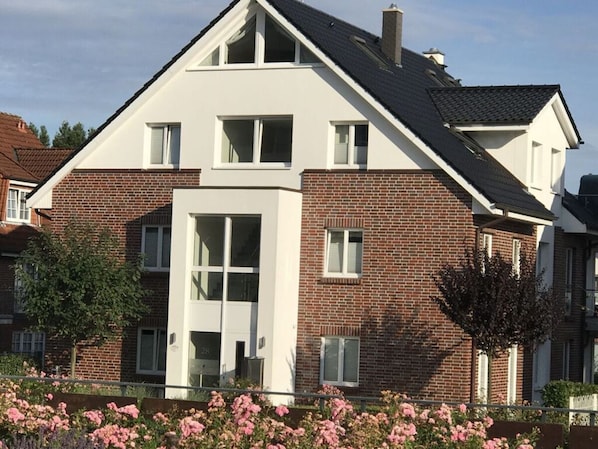 A two-story house with a brick facade and white trim.
